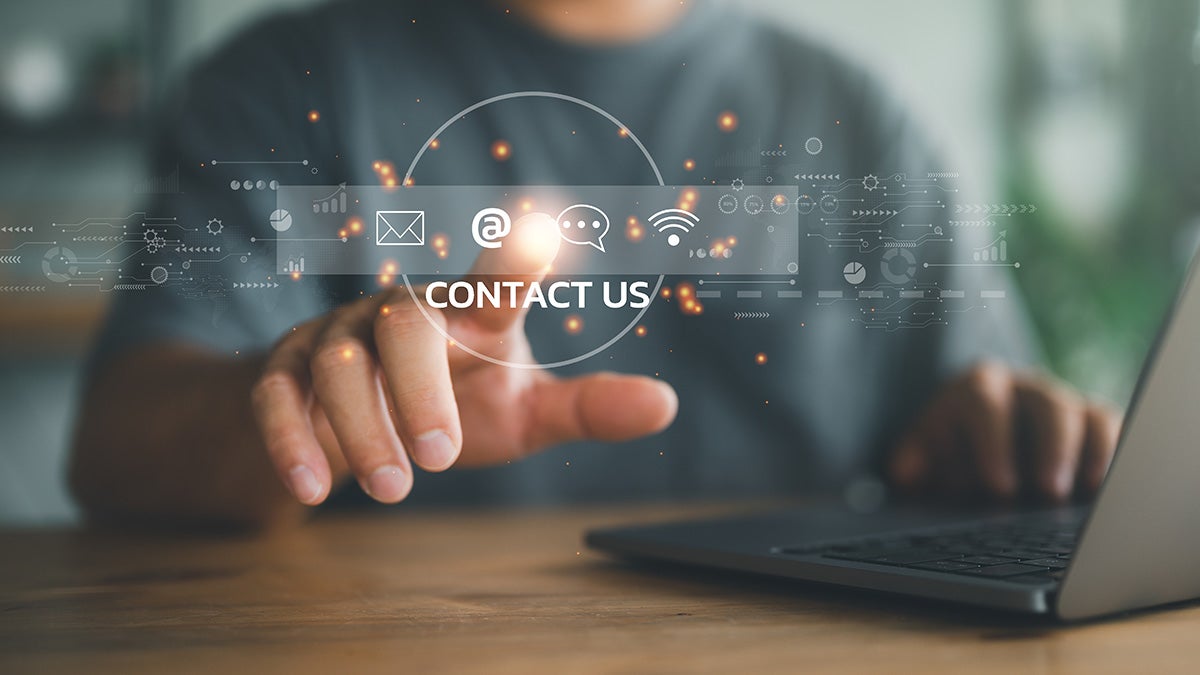 Man touching virtual CONTACT US bar with communication icons